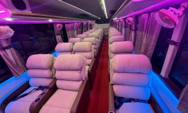 Ambient lighting inside the luxury sofa bus at night for a cozy and comfortable journey.