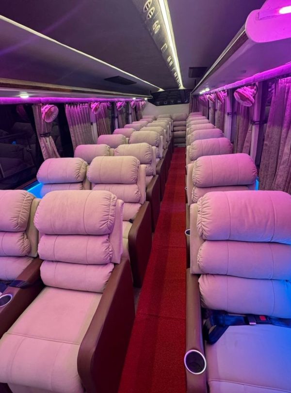 Ambient lighting inside the luxury sofa bus at night for a cozy and comfortable journey.