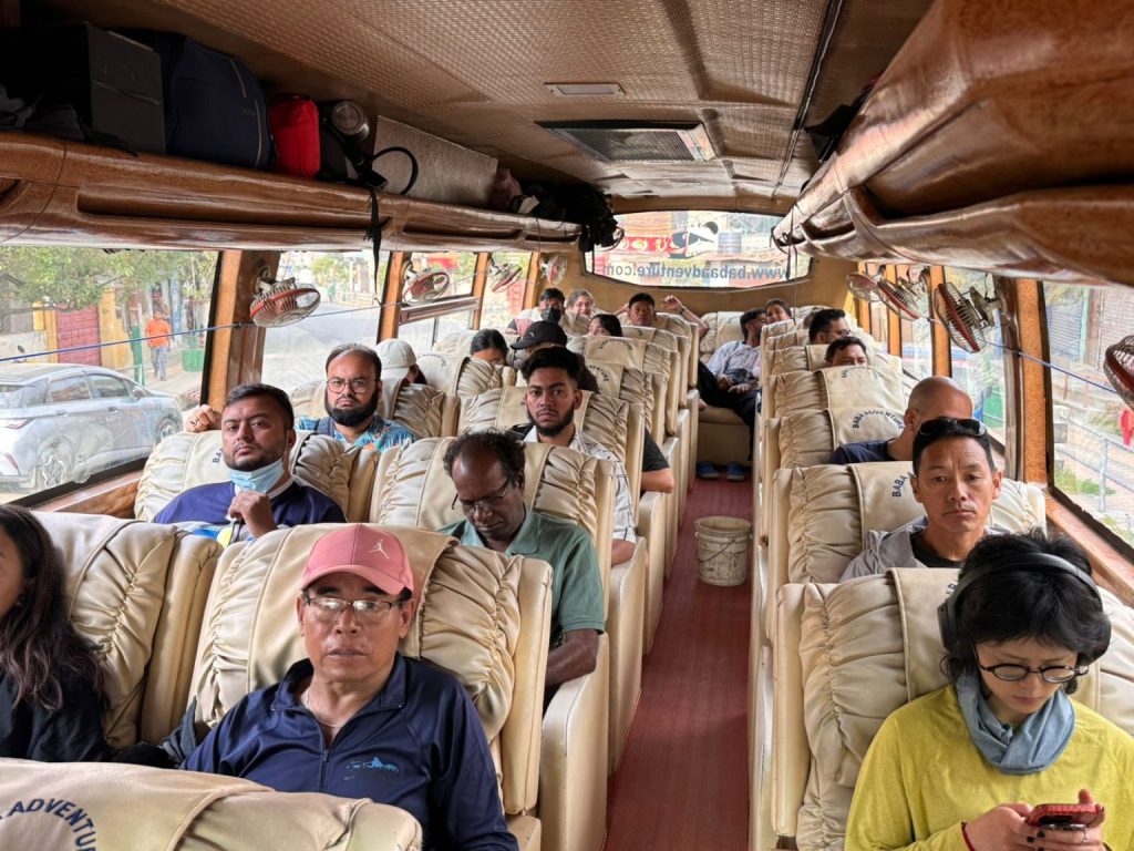Passengers enjoying a scenic and comfortable drive from Kathmandu to Pokhara in a luxury sofa bus.