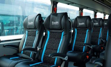 Interior view of a modern Volvo bus in Nepal showing comfortable seats and spacious layout.