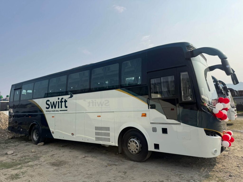 Volvo bus parked on a scenic Nepalese road, representing Volvo bus reservation services in Nepal.
