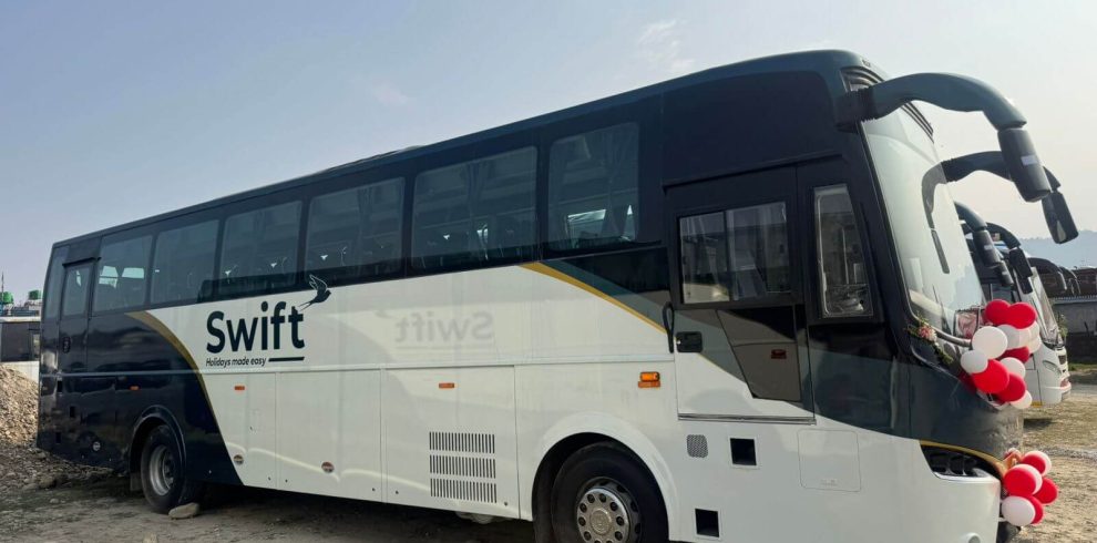 Volvo bus parked on a scenic Nepalese road, representing Volvo bus reservation services in Nepal.